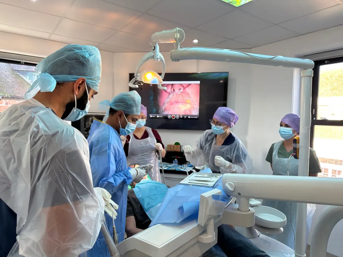 Two implant surgeons operating during a hands-on workshop